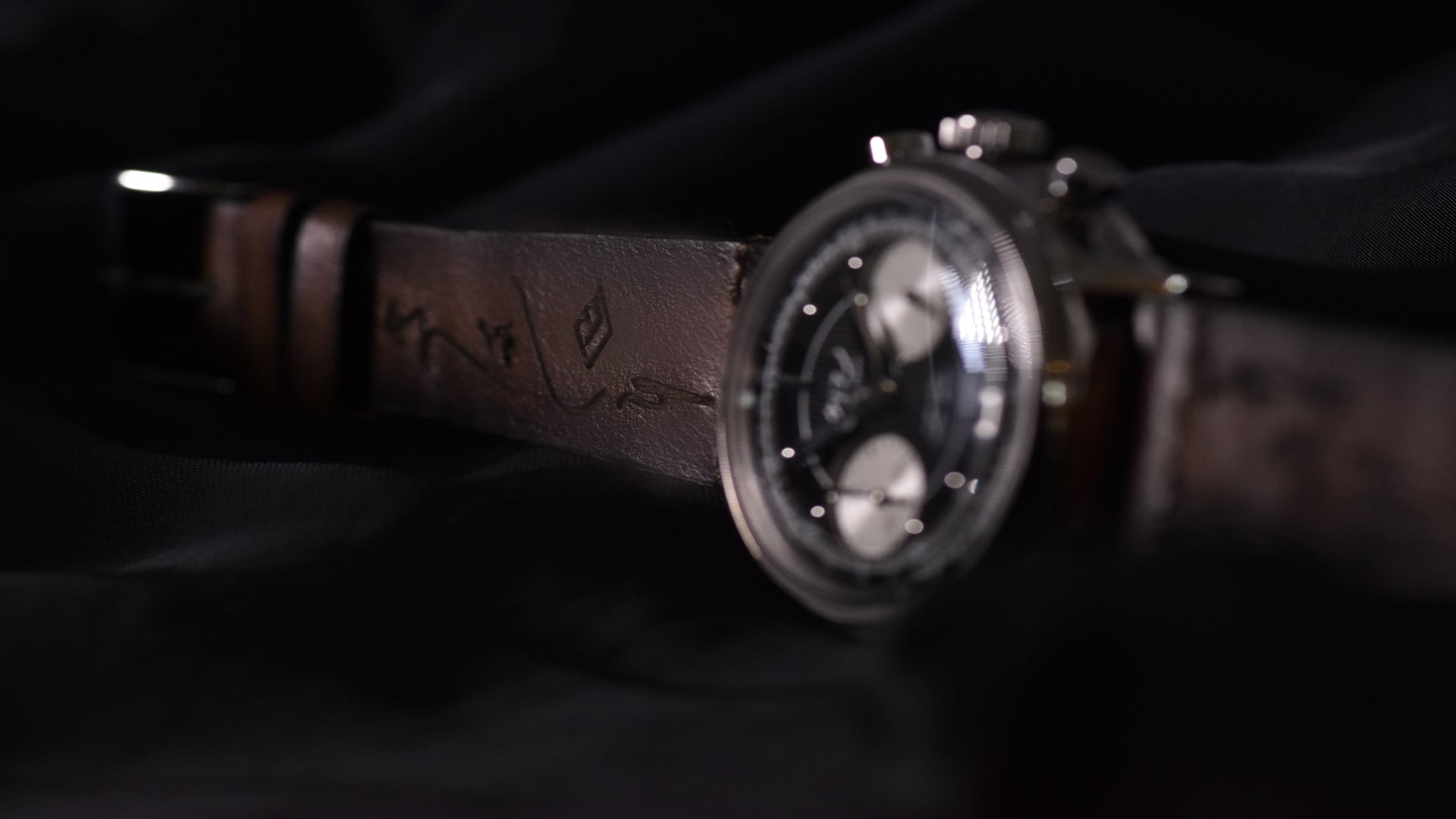 dark brown strap with black dial